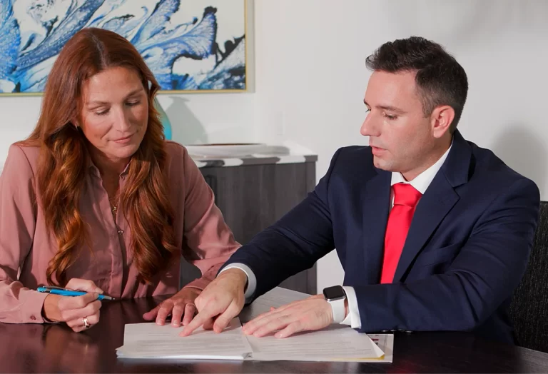 Attorney meeting with a client to review legal paperwork after a serious injury case
